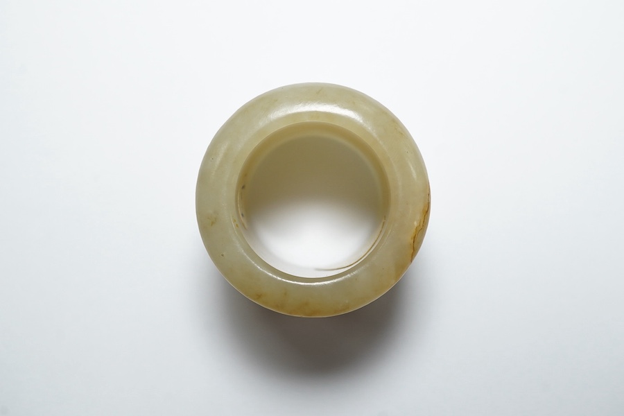 A Chinese pale celadon jade archer's thumb ring, 18th/19th century